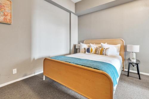 a bedroom with a large bed with a blue blanket at Littlefield Lofts, Hosted by Placemakr - 6th St in Austin