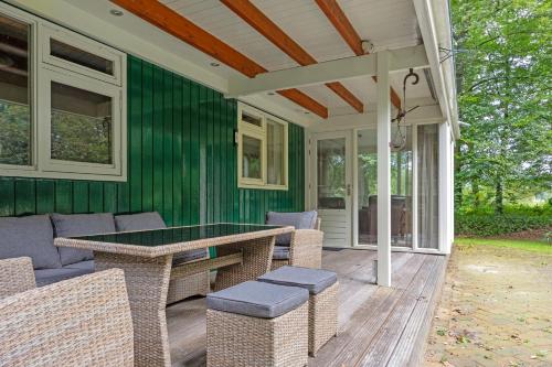 a screened in porch with a table and chairs at 't Laankholt in Bornerbroek