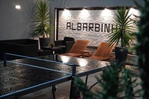 a restaurant with a table and chairs and a sign that reads alternative at AL Barbinha in Faro