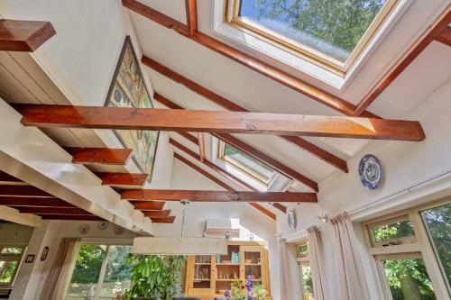 a room with skylights and wooden beams at 't Laankholt in Bornerbroek