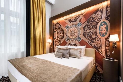 a bedroom with a bed with a large wall at Hotel Moments Budapest by Continental Group in Budapest