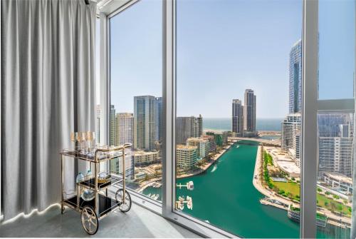 a room with a large window with a view of a city at Deluxe Marina View 2BR - Stella Maris Retreat in Dubai