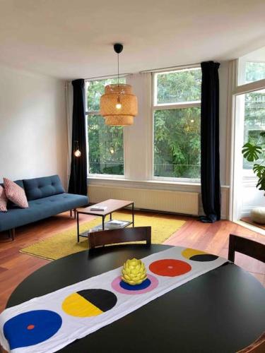 a living room with a table in the middle of it at The Rotterdam Suite in Rotterdam