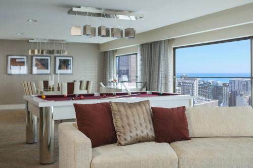 a living room with a couch and a pool table at Chicago Marriott Downtown Magnificent Mile in Chicago