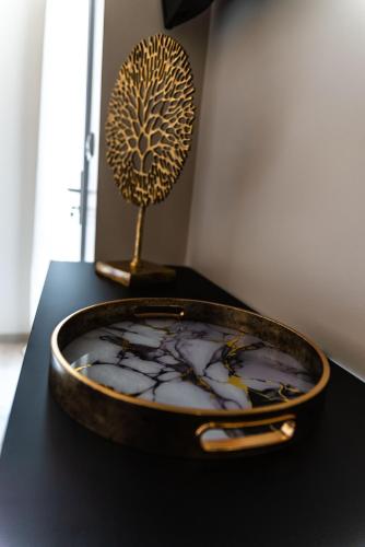 a bowl on a table with a tree on it at La Maison de Jade & Spa in La Roche-de-Glun