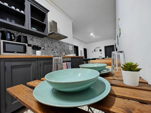 a kitchen with three bowls on a wooden table at Cosy room 4 in Pieta