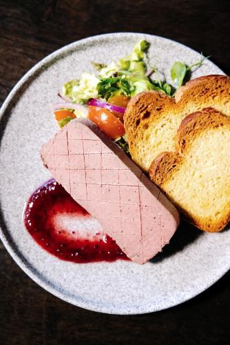 a plate of food with a sandwich and bread at Aherlow House Hotel & Lodges in Aherlow
