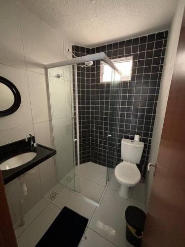 a bathroom with a shower and a toilet and a sink at Apto Noronha - próximo às praias litoral sul in Gramame