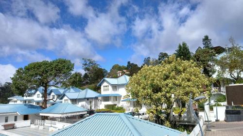 a row of houses with blue roofs at Le Poshe, Kodaikanal in Kodaikānāl