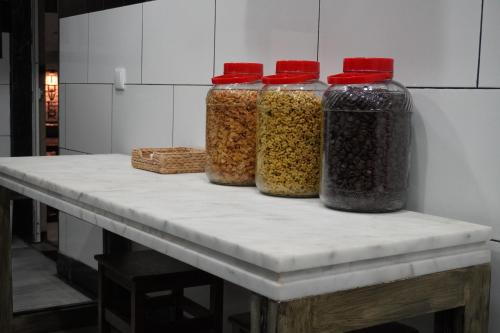 four glass containers of spices sitting on a table at AL Barbinha in Faro