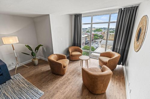 a living room with chairs and a large window at Littlefield Lofts, Hosted by Placemakr - 6th St in Austin