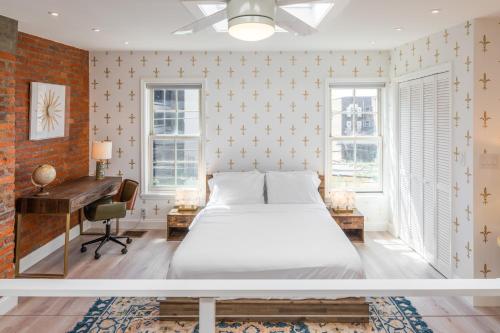 a bedroom with a bed and a desk and a piano at Modern Marvel at University City in Philadelphia