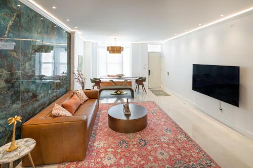 a living room with a couch and a tv at Modern Marvel at University City in Philadelphia