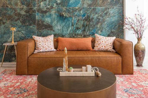 a brown couch in a living room with a table at Modern Marvel at University City in Philadelphia