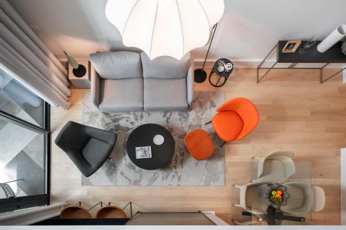 an overhead view of a living room with a couch and chairs at Savoy Insular Loft by An Island Apart in Funchal