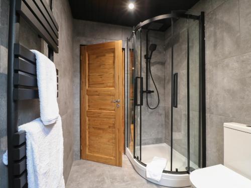 a bathroom with a shower and a glass door at Bee Hive in Oakham