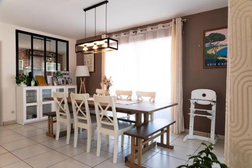 a kitchen and dining room with a table and chairs at La Maison de Jade & Spa in La Roche-de-Glun