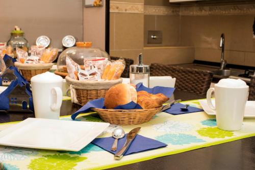 a table with baskets of bread and utensils on it at Bed & Breakfast Armonie Romane in Rome