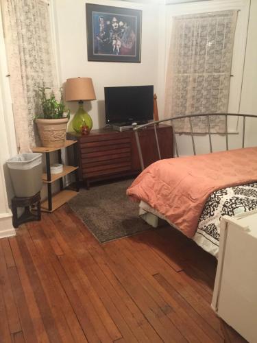 a bedroom with a bed and a desk with a television at Black Oak Rest in Philadelphia