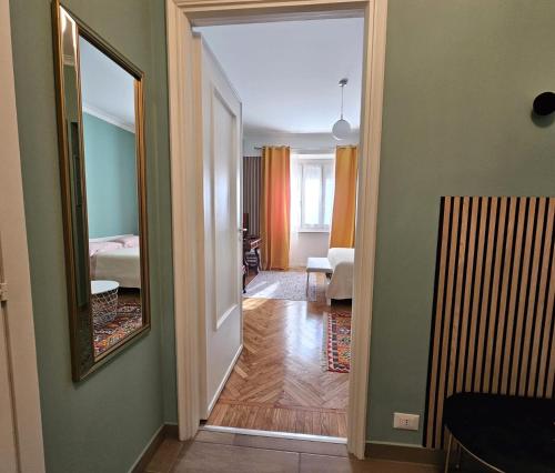 a hallway leading to a room with a mirror at Casa Torino Liberty in Turin
