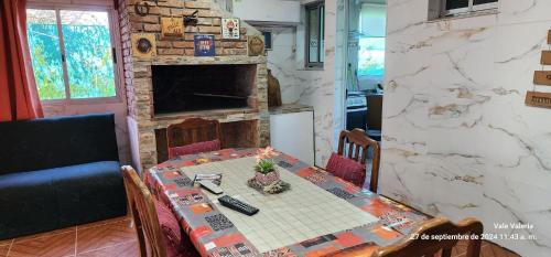 a dining room with a table and a fireplace at La Quimera a pasos de la playa in Atlántida