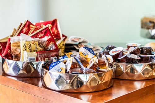 a group of three metal containers filled with food at Abacus Hotel in Sesto San Giovanni