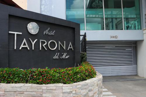 a sign for a taylorania store in front of a building at Hotel Tayrona del Mar in Santa Marta