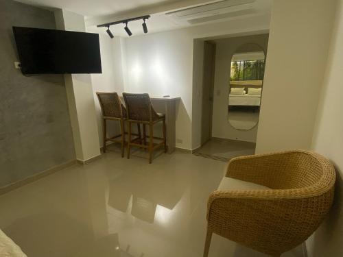 a living room with two chairs and a table at Maidy Luxury Hotel in Medellín