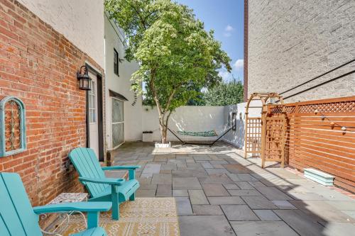 a patio with two chairs and a fence at Modern Marvel at University City in Philadelphia