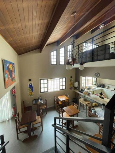 a large room with tables and chairs in a room at Pousada Chilli Brasil in Ubatuba