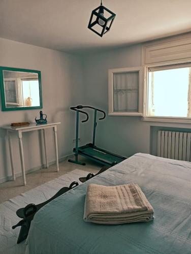 a bedroom with a bed with a towel on it at Villa avec piscine privée in Potinville