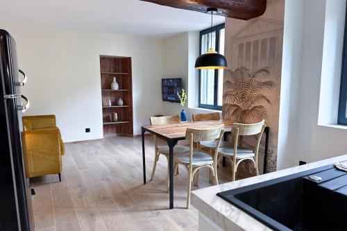 a kitchen with a dining room table and chairs at MACE Appartement avec SPA dans quartier Historique Exclusif Calme Coeur d'Antibes in Antibes