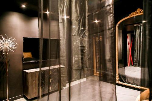 Cette chambre comprend un miroir et un lit. dans l'établissement LoveRoom, luxe & plaisir, à Villeurbanne