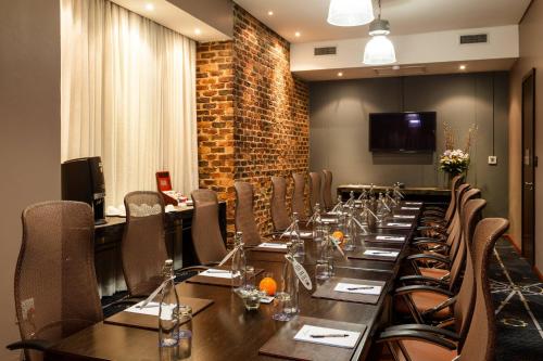 a conference room with a long table and chairs at Protea Hotel by Marriott O R Tambo Airport in Kempton Park