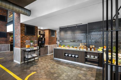 a restaurant kitchen with a buffet of food at Protea Hotel by Marriott O R Tambo Airport in Kempton Park