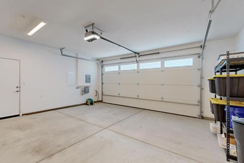 a garage with white walls and a white garage door at Rio Del Sol Retreat in Cathedral City