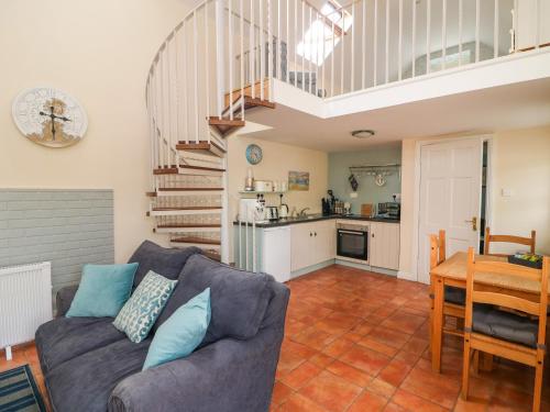 a living room with a couch and a table at Seaforest Lodge in Kildermot Cross Roads