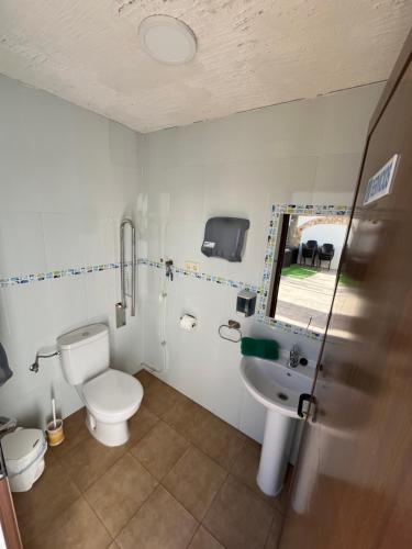 a bathroom with a toilet and a sink at Casa Rural Abuelo Raimundo in Ossa de Montiel