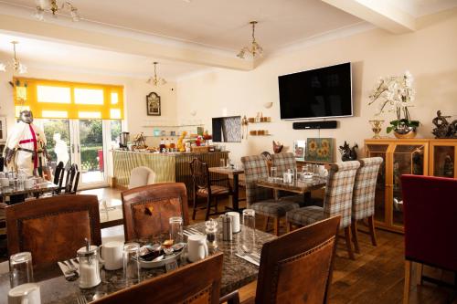 a restaurant with tables and chairs and a television at DORSET ARMS HOTEL in Newcastle upon Tyne