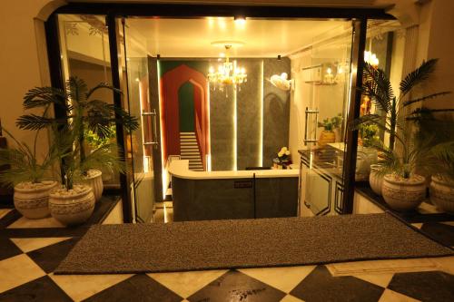 a bathroom with potted plants on a checkered floor at Jaipur Qila - A Boutique Hotel and Rooftop Cafe in Jaipur