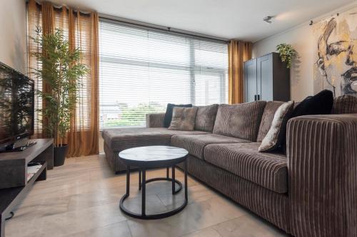 a living room with a couch and a table at De Schelp 58 in Zandvoort