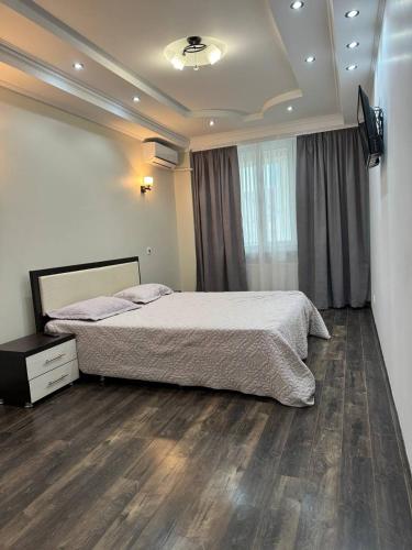 a bedroom with a large bed and a television at Style Aparts in Chişinău
