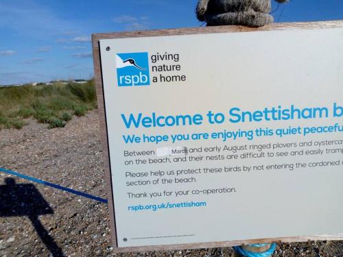 a sign that says welcome to the australian beach at The Patch at Snettisham Beach in Snettisham