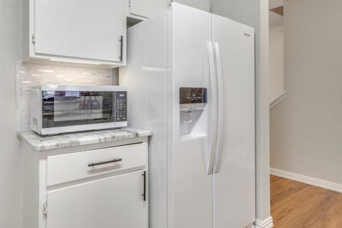 a kitchen with a white refrigerator and a microwave at 4 Mi to Gaylord Family Stadium Norman Home in Norman