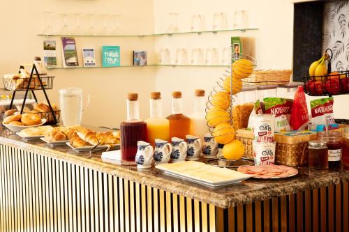 a buffet with bread and orange juice and other food at DORSET ARMS HOTEL in Newcastle upon Tyne