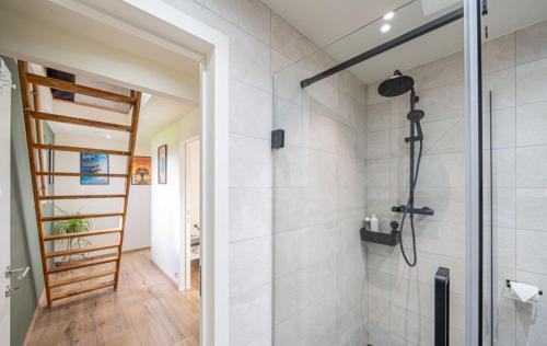 a bathroom with a shower with a glass door at Côté Jardin in Buvrinnes