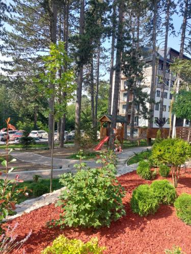 a park with a playground and a building at Titova Vila Apartman Jelka in Palisad
