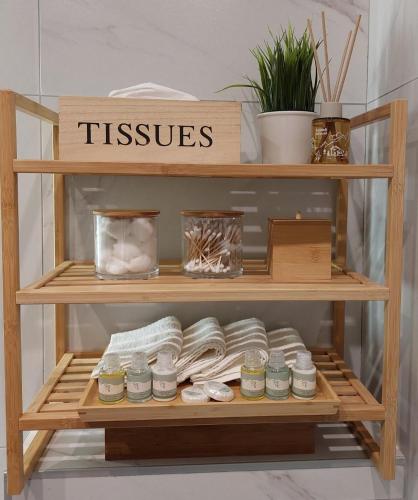 a wooden shelf with jars and plants on it at Titova Vila Apartman Jelka in Palisad