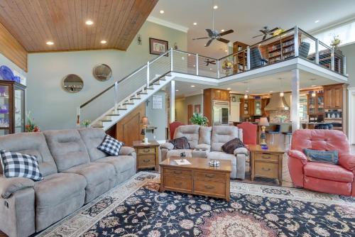 a living room with two couches and a staircase at Fish, Swim and More Lakefront Alabaster Home in Alabaster