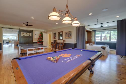 a living room with a pool table at Fish, Swim and More Lakefront Alabaster Home in Alabaster